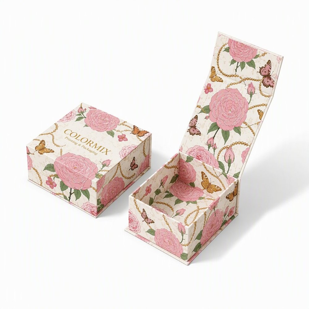 Rose and butterfly printed flip-lid rigid box for a candle, shown closed beside the open box with its gold interior