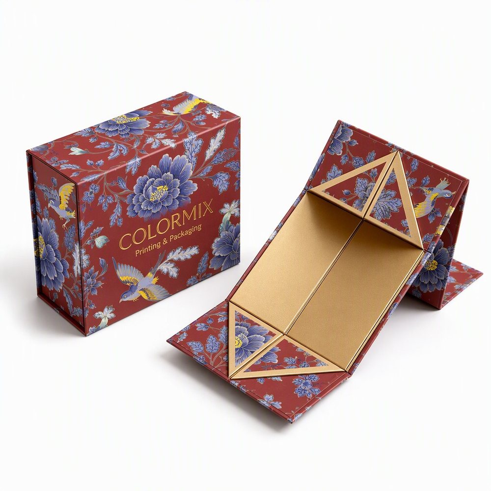 Collapsible magnetic box folded flat beside the open box, floral print with a gold interior