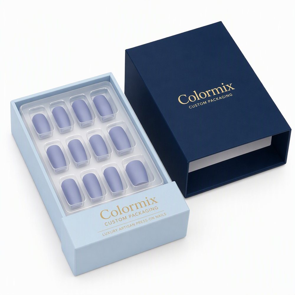 Navy lid and pale blue tray for a press-on nail set, twelve tips in moulded cavities, gold foil logo