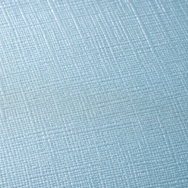 Close-up of a linen-embossed light blue specialty paper