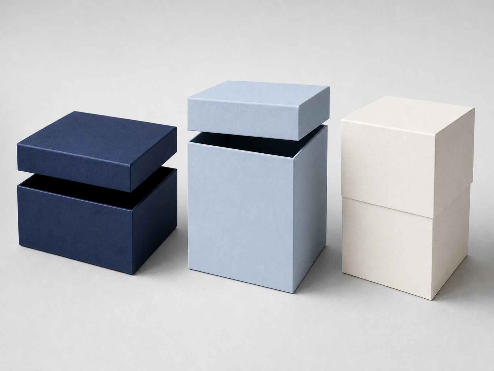 Three rigid box structures side by side: shallow book-style lid, deep base with short lid, and telescoping lid and base box