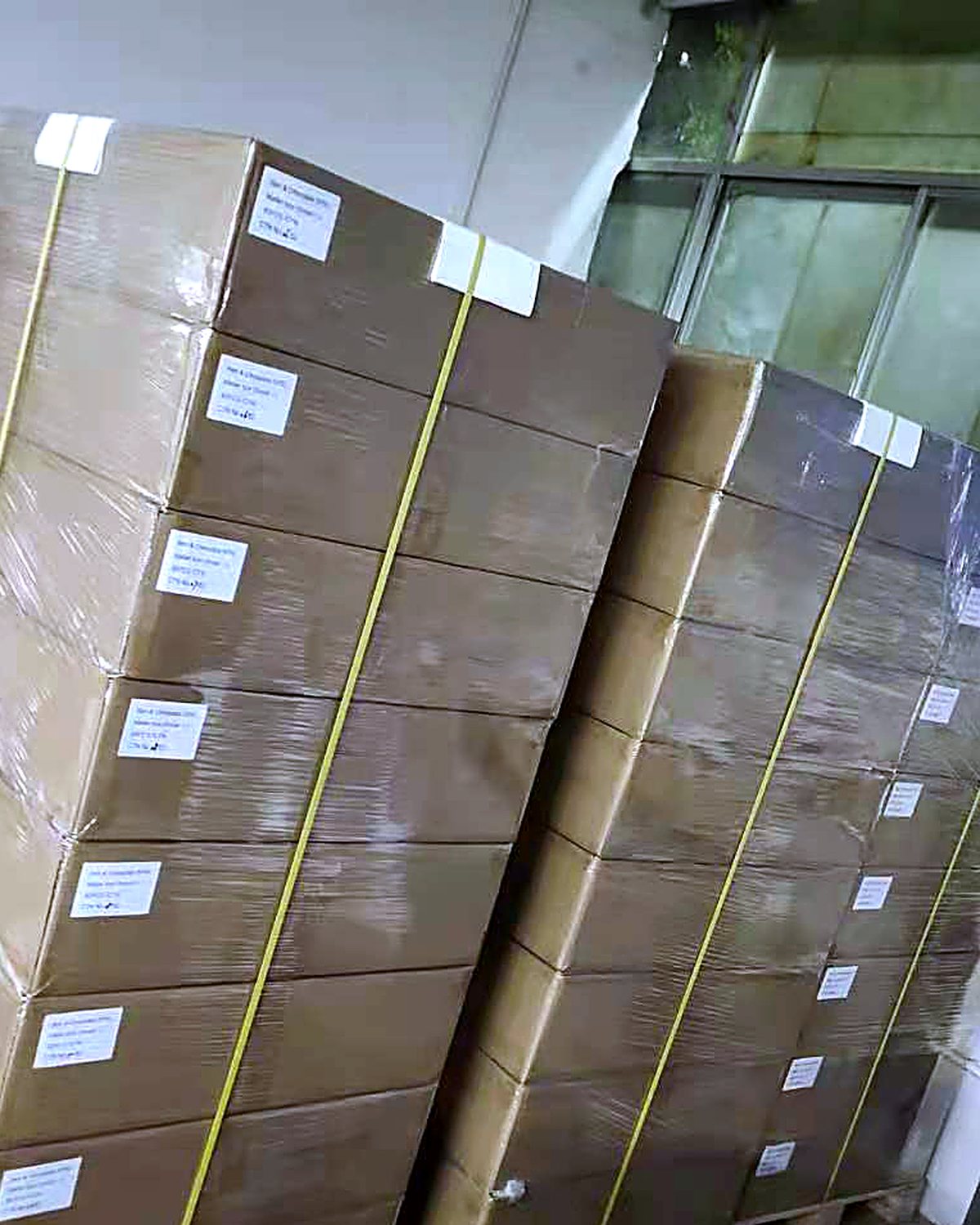 Two wrapped pallets of cartons staged for collection