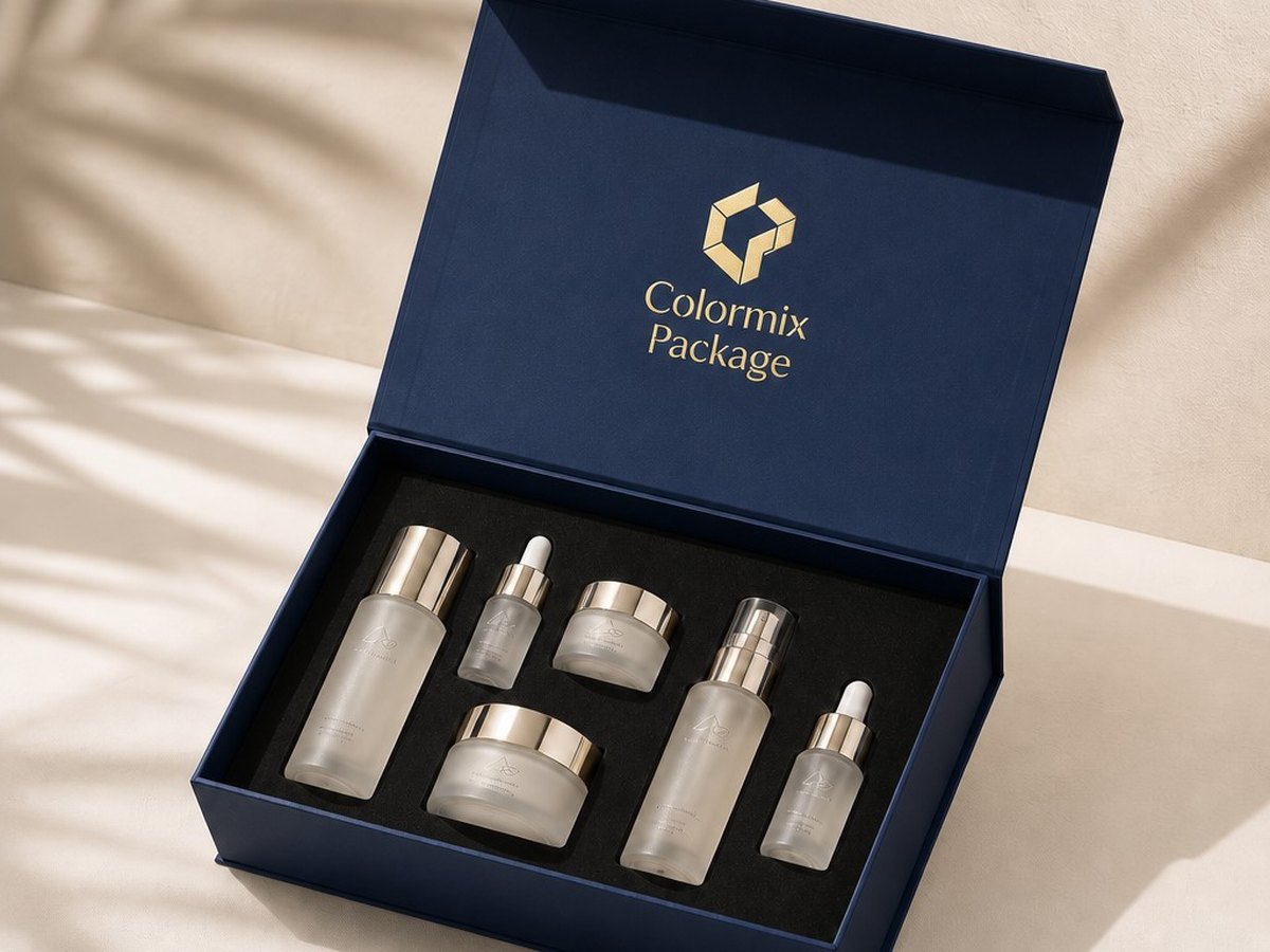 Navy rigid gift box with a foam insert holding a five-piece skincare set, branded Colormix